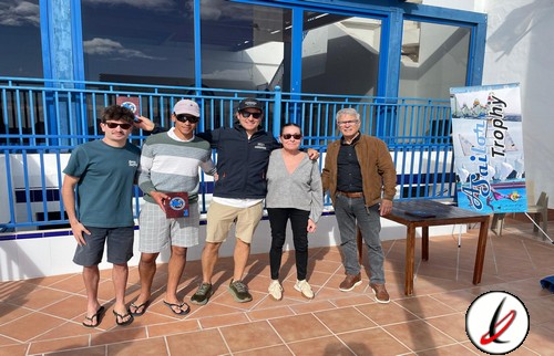 Hombres y mujer posando con trofeo en terraza exterior de Lanzarote Deportiva.